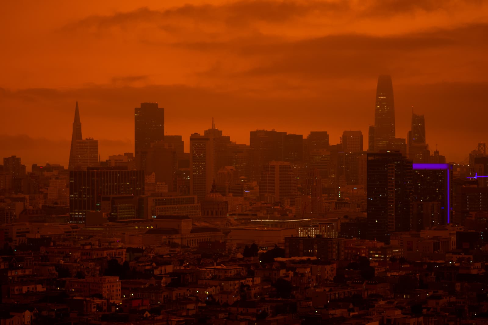 The San Francisco skyline. The entire city is dark orange, almost as if it were a photo taken on Mars.